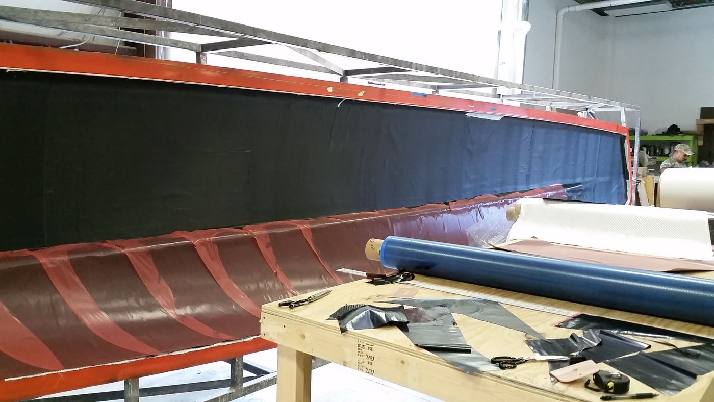 Laying prepreg into the hull mold, August 2016.