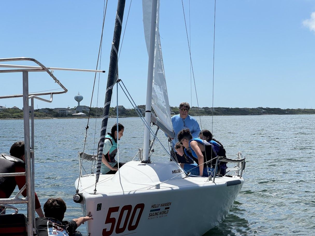 Coaching young sailors on a Melges 24.
